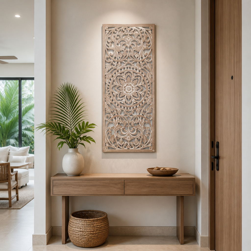 A tall rectangular carved wooden wall art piece with intricate floral mandala patterns, displayed in a modern entryway above a light wood console table.