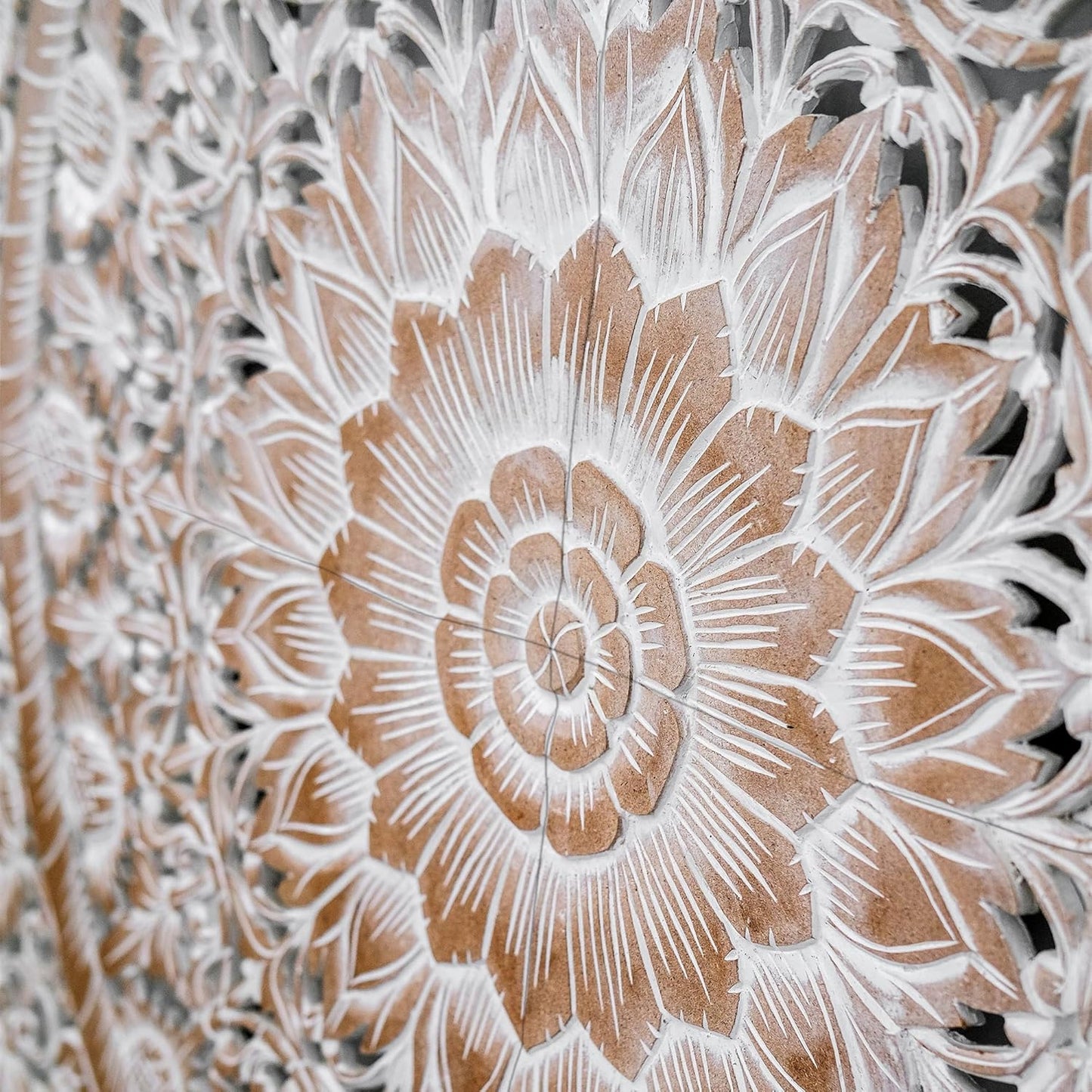 Close-up of a detailed floral carvings on a wooden panel.