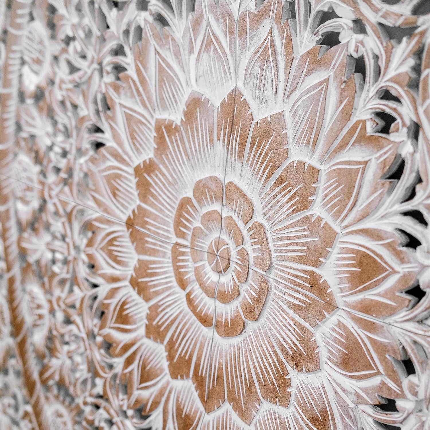 Close-up of a detailed floral carvings on a wooden panel.