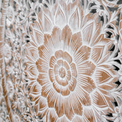 Close-up of a detailed floral carvings on a wooden panel.