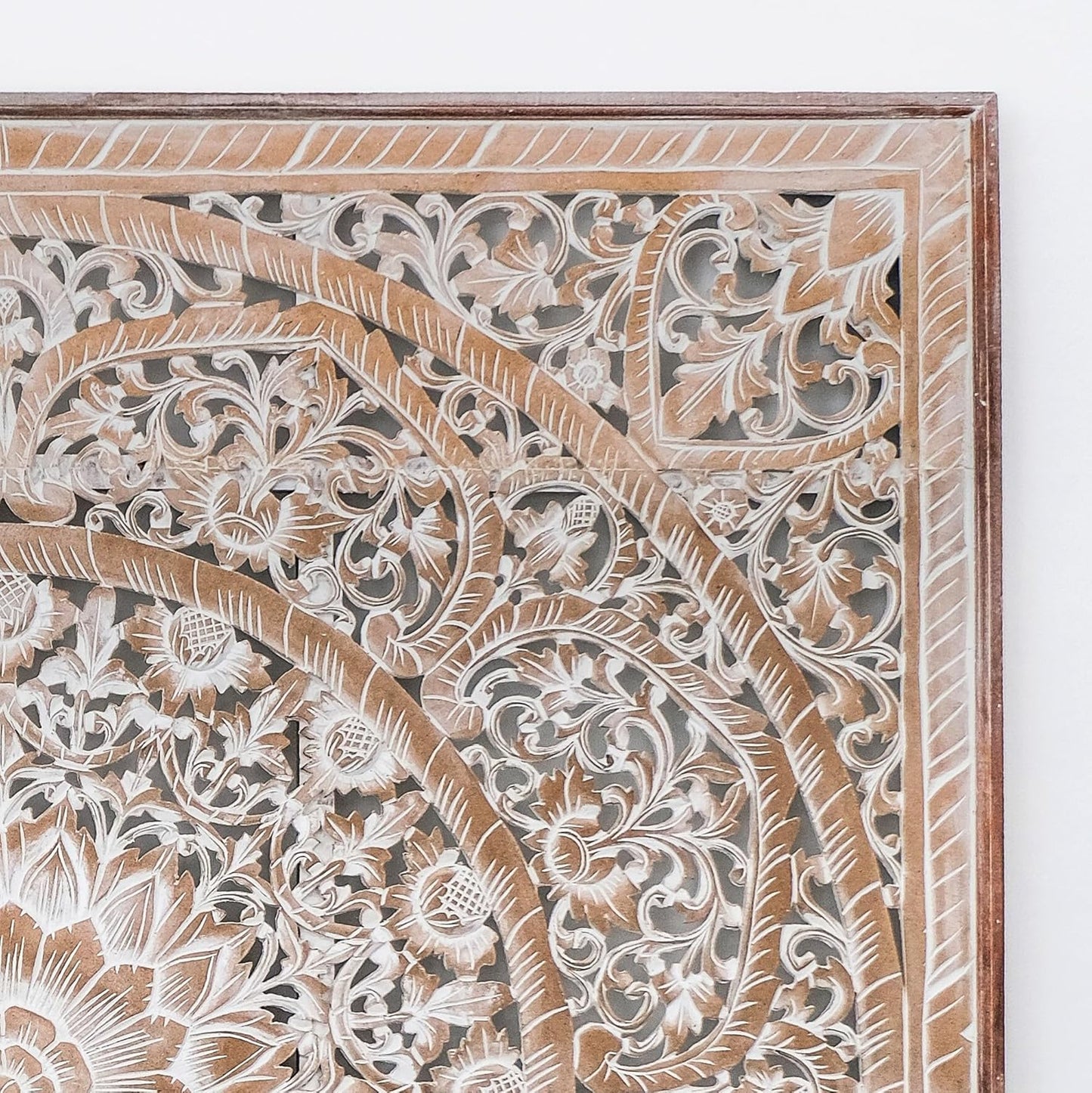 Close-up of a wooden panel with intricate carvings on a white background